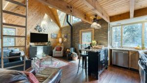 a living room of a log cabin with a kitchen at Jeffrey Pines Lofted Cabin Minutes to Lake A-Frame-Inspired Design Deck in Truckee