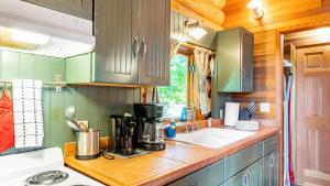 a kitchen with a counter with a coffee maker on it at Penn Cove Overlook by AvantStay Cabin w Views in Oak Harbor +21 photos