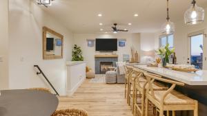 a kitchen and living room with a table and chairs at Sunset Serenity by AvantStay Rooftop w Hot Tub Fire Pit 3 Blocks to Beach in Pismo Beach