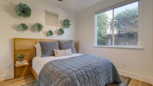 a bedroom with a bed and a window at Sunset Serenity by AvantStay Rooftop w Hot Tub Fire Pit 3 Blocks to Beach in Pismo Beach +42 photos