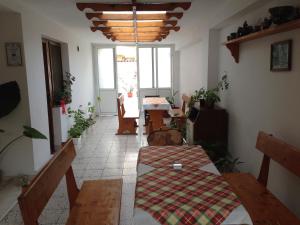 a living room with a table and chairs in a room at Gloria Holiday House in Nesebar