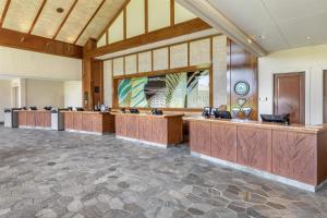 a large lobby with wooden desks in a building at Hilton Grand Vacations Club Kings Land Waikoloa in Waikoloa +61 photos