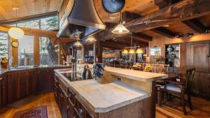 an open kitchen with a large island in a house at Mt. Jola by AvantStay A 5-minute walk away to Palisades and lifts. in Olympic Valley