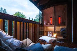 a screened in porch with a table on a deck at Gora Luxury Apartments in Kranjska Gora