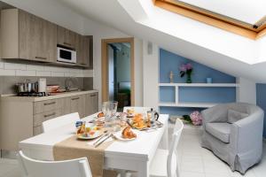 a kitchen and dining room with a white table and chairs at Greco b&b in Agropoli