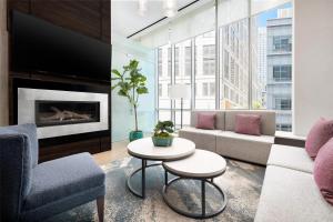 a living room with a couch and a fireplace at Hilton Garden Inn New York - Times Square Central in New York +55 photos