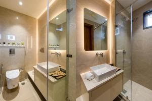 a bathroom with a toilet and a sink and a shower at Hotel Exotica Avenue - Business-Friendly Stay, Golf Course Road, Cyberhub, One Horizon Center & Metro in Gurgaon