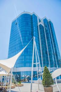 a large glass building with a lot of windows at Golden Coast Hotel in Baku