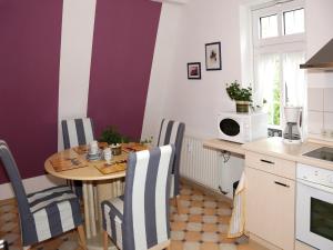 a kitchen with a table and chairs and a table and a microwave at Relaxa at a luxurious villa in Bad Pyrmont in Bad Pyrmont +96 photos