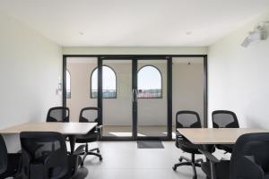 a conference room with tables and chairs and windows at Fantasea Condo Kamala A209 2BDRM by Phuket Sabay Rent in Kamala Beach