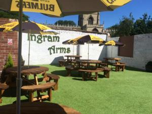 a group of picnic tables and umbrellas on the grass at Ingram Arms, HATFIELD in Doncaster