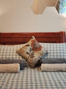 a bed with a pillow and pillows on it at Hawaii Theme Ortigas MRT Ayala 30th Megamall Podium Free Netflix Fast Internet Pool in Manila