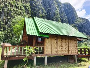 a small wooden house with a green roof at Namnoncave Resort 