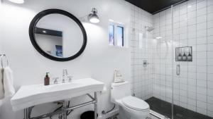 a bathroom with a sink and a toilet and a mirror at Rock n Roll by AvantStay Vibey 2BDR in Prime Hollywood Steps to Attractions in Los Angeles +11 photos