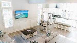 a living room with a couch and a table at Walk to Beach 2 Shared Pools Enclosed Porch Bikes 30A Hideaway by AvantStay in Santa Rosa Beach