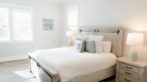 a white bedroom with a large bed with pillows at Walk to Beach 2 Shared Pools Enclosed Porch Bikes 30A Hideaway by AvantStay in Santa Rosa Beach +27 photos