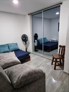 a living room with a couch and a large window at Casa Flandes hermosa y muy cerca de todo in Flandes