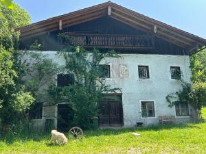 an old house with a goat in front of it at 1690 Heritage Farmhouse-barn in Kuchl