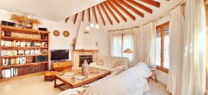 a living room with a couch and a table at Villa Valle El Portet in Cumbre del Sol
