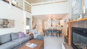 a living room with a couch and a tv and a table at Etta Place Too 113 by AvantStay Close to Town The Slopes In Complex w Communal Pool Hot Tub in Telluride