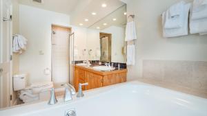 a bathroom with a tub and a toilet and a sink at Etta Place Too 113 by AvantStay Close to Town The Slopes In Complex w Communal Pool Hot Tub in Telluride +38 photos