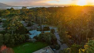 an aerial view of a neighborhood with trees and a sunset at Sunridge Lookout by AvantStay Big Backyard Oasis Patio Central Location in Del Monte Forest