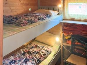 two bunk beds in a small room with at 4 person holiday home in Eresfjord-By Traum in Øverås
