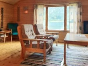 a living room with two chairs and a table at 4 person holiday home in Eresfjord-By Traum in Øverås