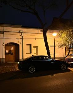 a car parked in front of a building at night at 4ML Boutique Room in Debrecen
