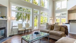 a living room with a couch and a table at Langley by the Sea by AvantStay Panoramic Vistas in Langley
