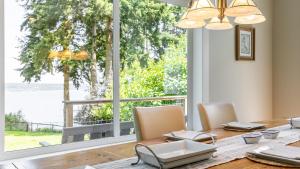 a dining room with a table and a large window at Langley by the Sea by AvantStay Panoramic Vistas in Langley +34 photos