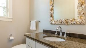 a bathroom with a sink and a toilet and a mirror at Langley by the Sea by AvantStay Panoramic Vistas in Langley