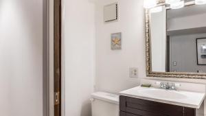 a white bathroom with a sink and a mirror at Eagles Watch by AvantStay Large Deck w Views in Coupeville +26 photos