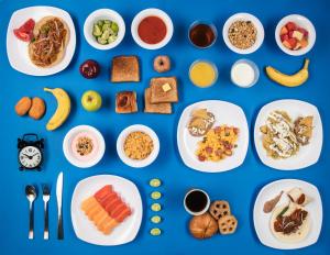 a collage of breakfast foods on plates on a blue background at One Monclova in Monclova