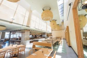 a dining room with wooden tables and chairs at amba Taipei Songshan in Taipei