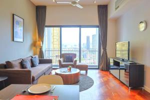 a living room with a couch and a tv at The Mews Kuala Lumpur in Kuala Lumpur