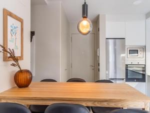 a dining room with a wooden table and chairs at NATUSliving Benasque E in Benasque