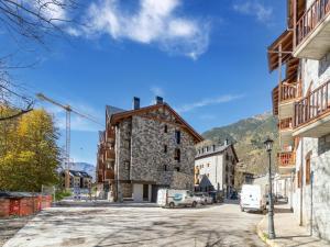 a street in a small town with a stone building at NATUSliving Benasque E in Benasque