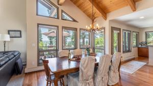 a dining room with a table and chairs and windows at Crystal View by AvantStay Al Fresco Dining w View of Lake Tahoe Crystal Bay in Incline Village