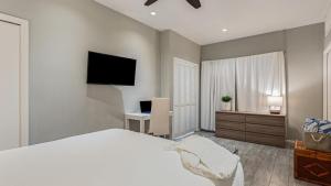 a bedroom with a bed and a desk and a television at Cayucos Duo 2 Bungalows w Views Lounge Space Pet Friendly in Cayucos
