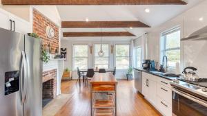 a kitchen with a wooden table in the middle at Sage Lodge by AvantStay 15 Min to Downtown Deck in Asheville