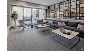 a living room with a couch and tables at CozySuites Marquee in Minneapolis