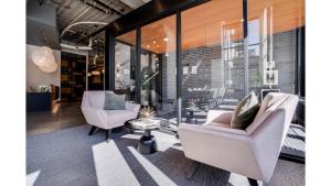 a living room with two chairs and a table at CozySuites Marquee in Minneapolis