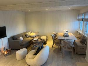 a living room with a couch and a table at Hovden Alpin Apartments in Bykle