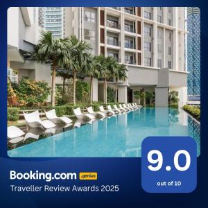 a picture of a hotel swimming pool with lounge chairs at The Mews Kuala Lumpur in Kuala Lumpur
