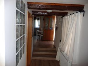 a hallway with stairs leading to a dining room at Förhénc Wine House & Guesthouses I-II-III in Nagykanizsa