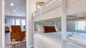 ein Schlafzimmer mit einem Etagenbett und einem Stuhl in der Unterkunft Cozy 2BR Fawnskin Cabin Big Bear Lake Hiking Trails Snow Summit Nearby in Fawnskin