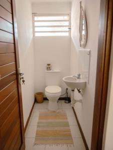 a bathroom with a toilet and a sink at Canopy House in Tamarin