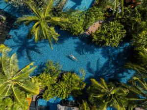 an overhead view of a swimming pool with palm trees at The St. Regis Bali Resort in Nusa Dua