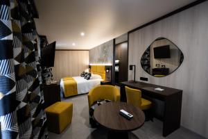 a hotel room with a bed and a table at In Secreto in Dunières